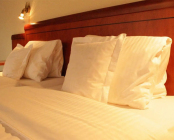 Comfortable bed with soft bed linen HotelWestend_Bett